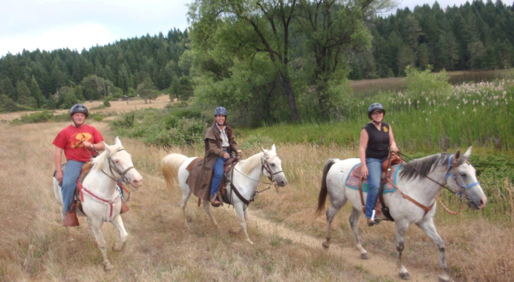 Three riders of the Risin' W Corral on Lake Loop between the Shotgun Range and Campfire.