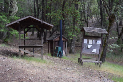 Madrone campsite bulletin board, hand-washing station and KYBO.