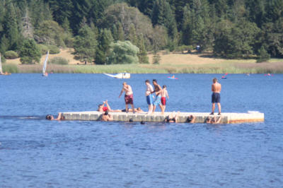 Scouts on the outdock of Watefront with boaters in the background.